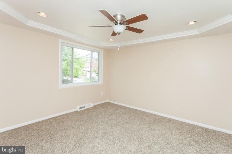 5540 Silverbell Road Baltimore, MD 21206 - Photo 26 of 30 an empty room with a ceiling fan and a window
