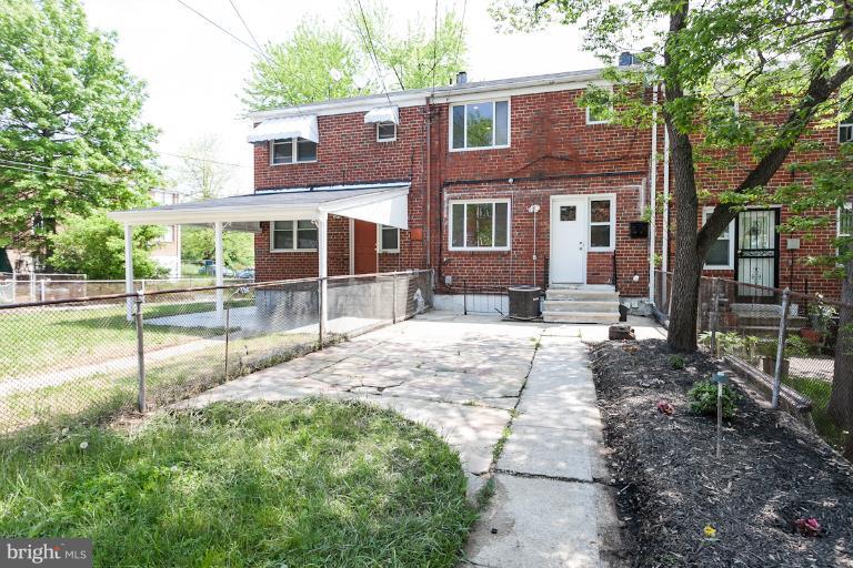 5540 Silverbell Road Baltimore, MD 21206 - Photo 27 of 30 a view of a brick house with a yard and plants