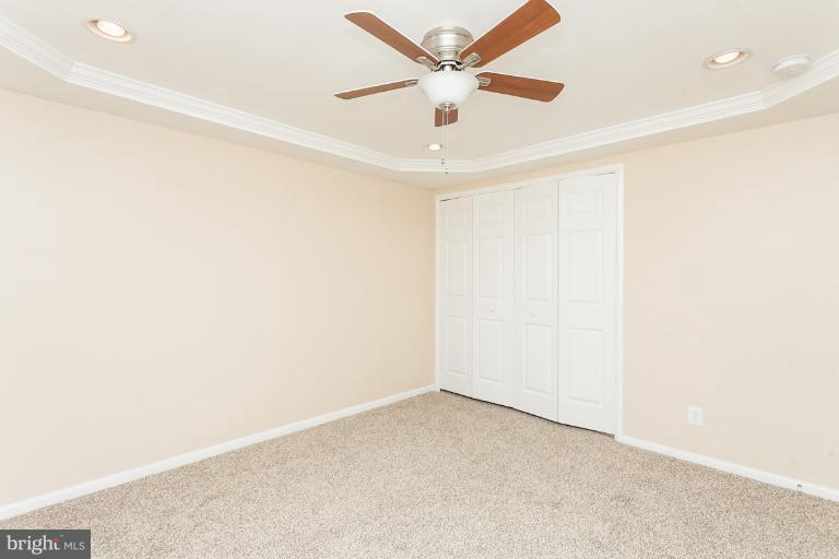 5540 Silverbell Road Baltimore, MD 21206 - Photo 29 of 30 an empty room with a ceiling fan and a window