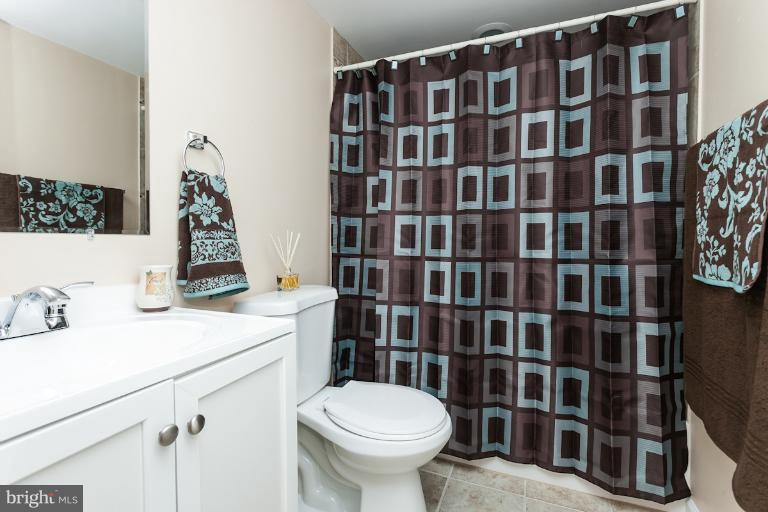 5540 Silverbell Road Baltimore, MD 21206 - Photo 7 of 30 a bathroom with a sink toilet and shower