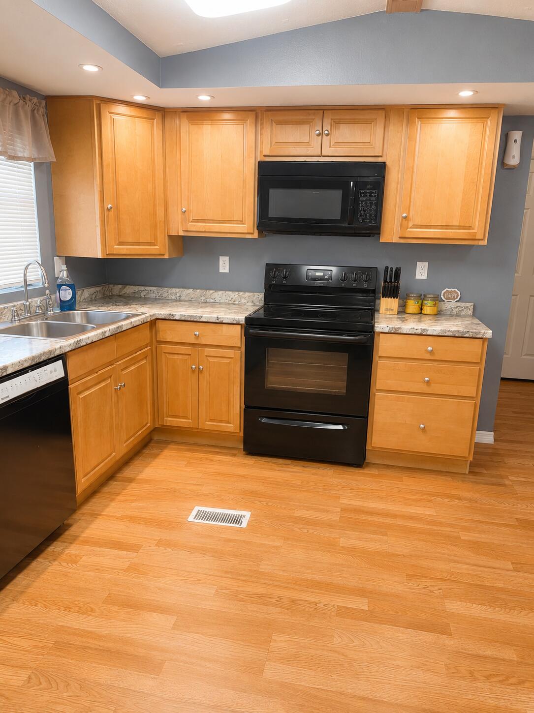 2547 Chatham Way Northeast Palm Bay, FL 32905 - Photo 15 of 24 a kitchen with stainless steel appliances a stove a sink and a microwave