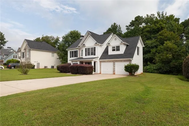 a front view of a house with a garden