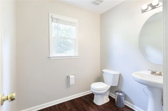 a white toilet sitting next to a bathroom sink