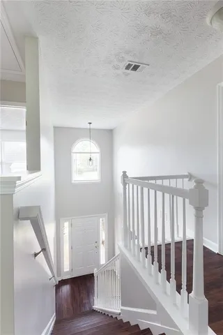 a view of staircase with white walls and a window