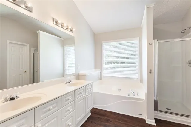 a spacious bathroom with sink shower and bathtub