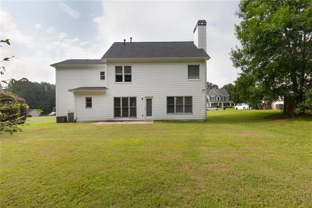 a front view of house with yard and trees