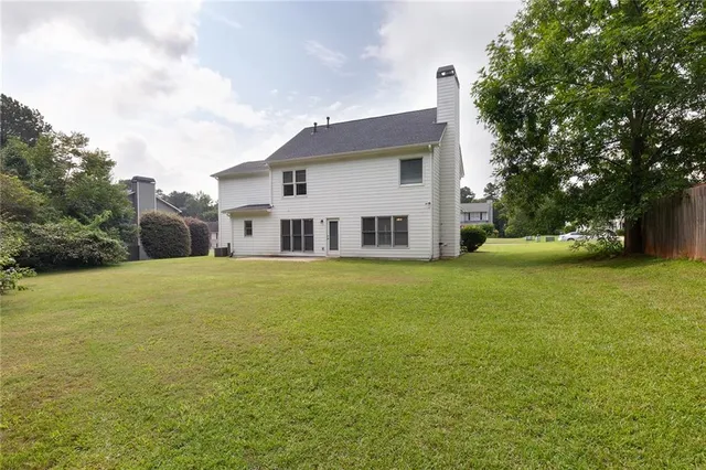 a house view with swimming pool in front of it