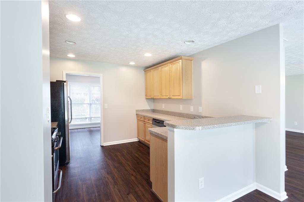 49 Parkside Drive Dallas, GA 30157 - Photo 8 of 31 a kitchen with a refrigerator and a stove top oven