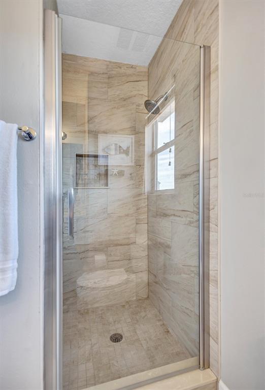 436 Canal Road, Unit A Sarasota, FL 34242 - Photo 61 of 94 a bathroom with a glass door shower
