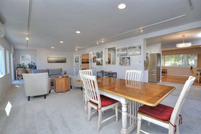 a dining room with furniture and wooden floor