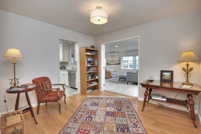 a living room with furniture and a bookshelf
