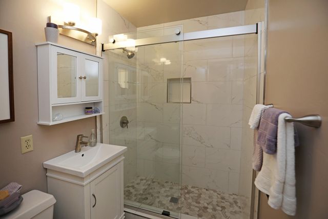 a bathroom with a sink toilet and shower