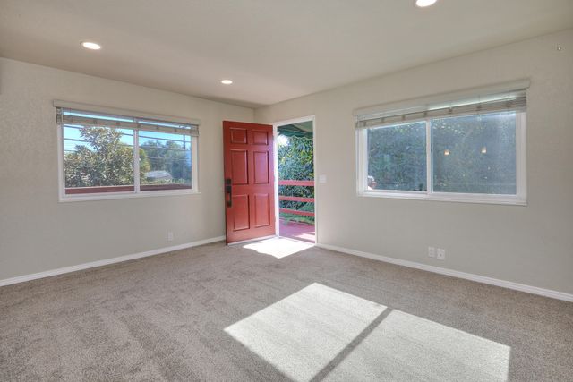 a view of an empty room with windows
