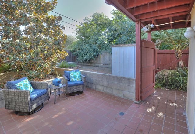 a backyard of a house with outdoor seating and green space