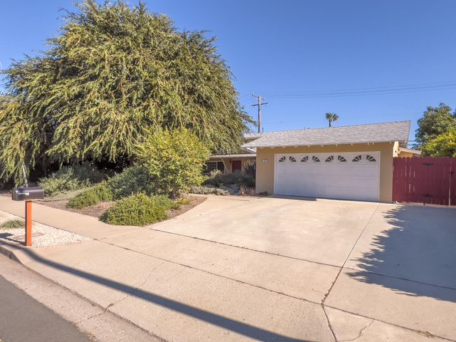a view of parking space and yard