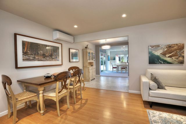 a living room with furniture and a view of kitchen