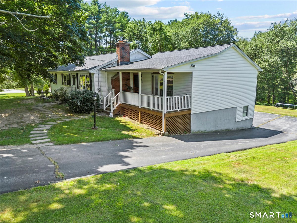 88 Pompeo Road Thompson, CT 06255 - Photo 12 of 40 a view of a house with a yard and a patio