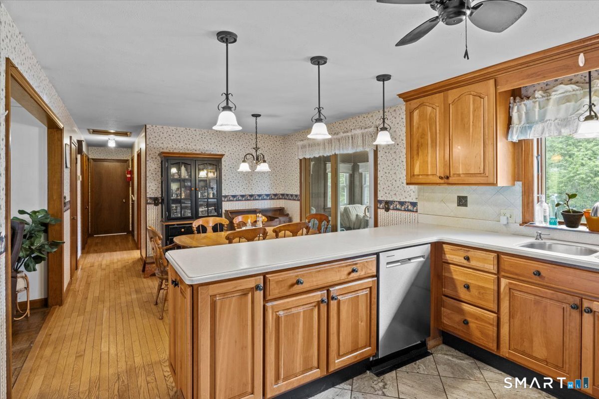 88 Pompeo Road Thompson, CT 06255 - Photo 16 of 40 a kitchen with kitchen island granite countertop a center island a counter space wooden floor and appliances