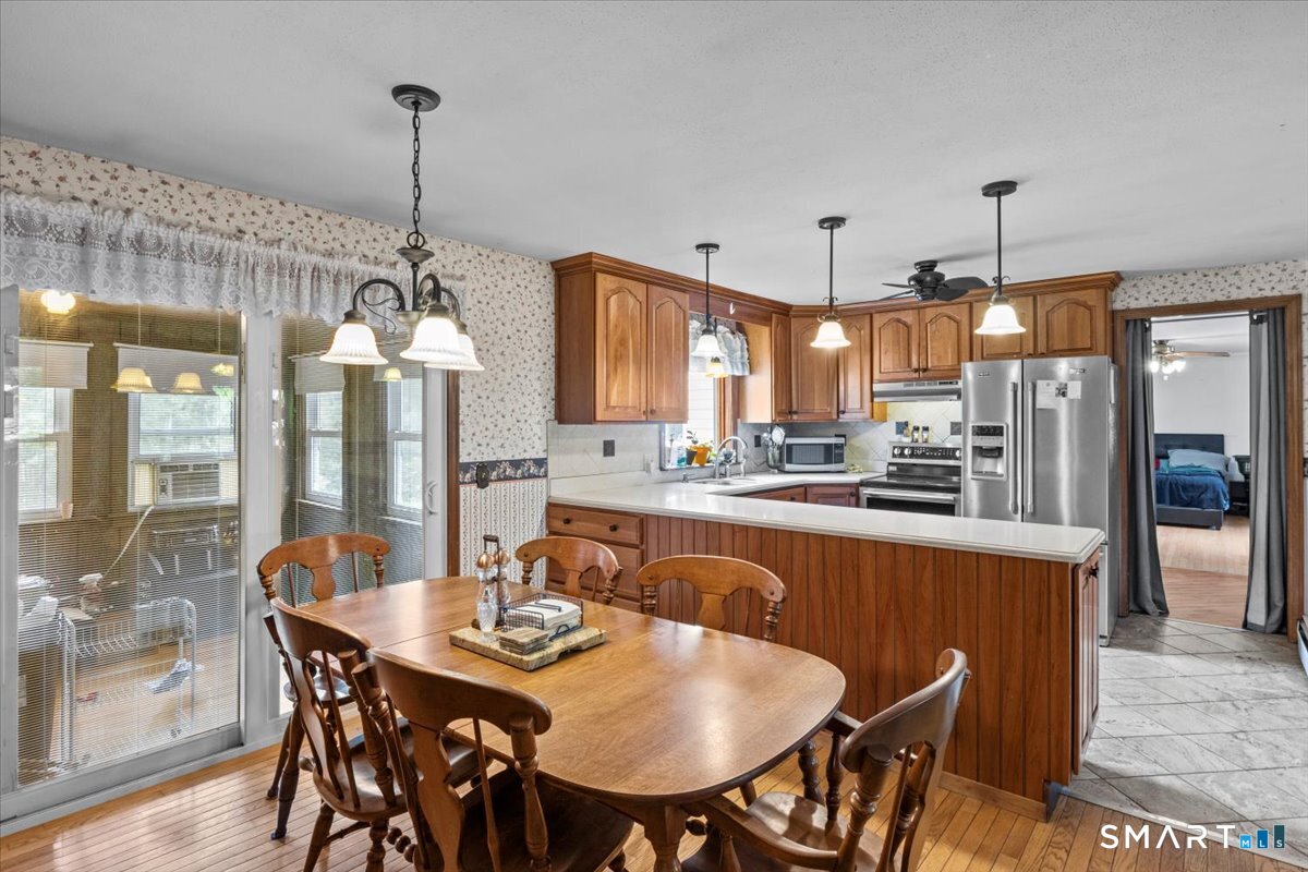 88 Pompeo Road Thompson, CT 06255 - Photo 17 of 40 a dining table chairs and a kitchen view