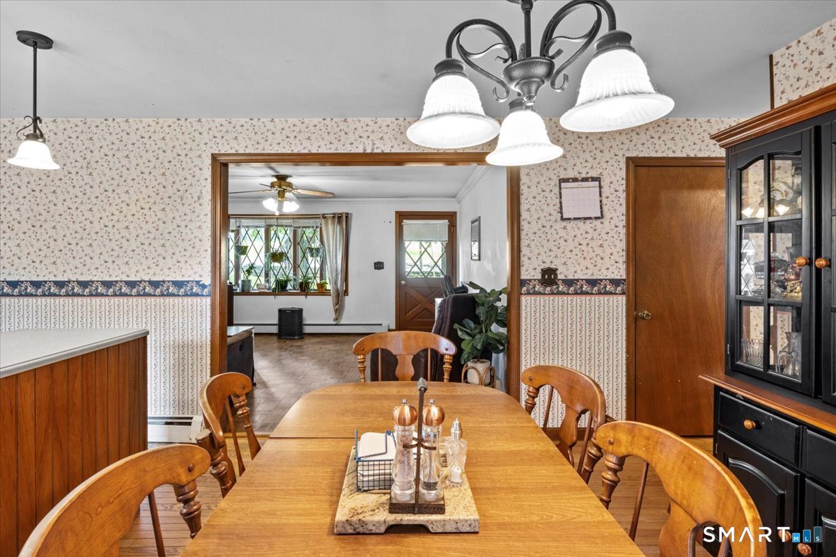 88 Pompeo Road Thompson, CT 06255 - Photo 18 of 40 a living room with furniture a chandelier and wooden floor