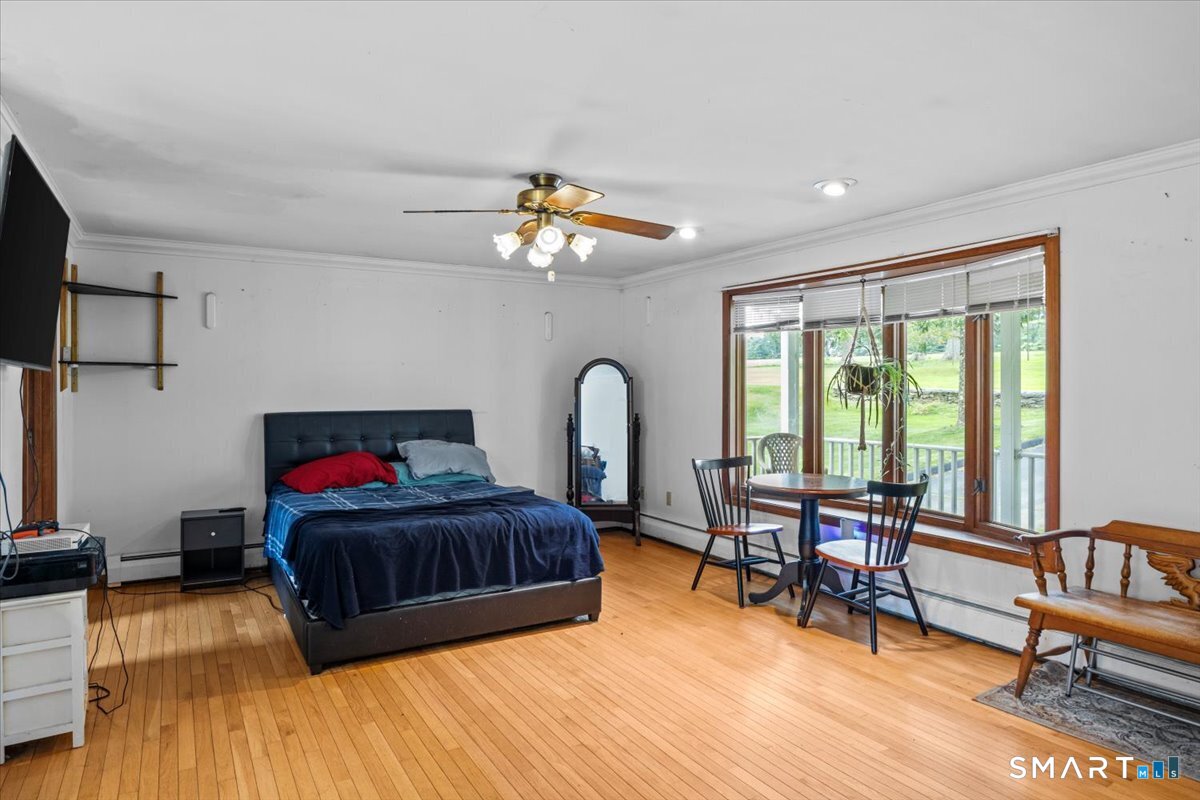 88 Pompeo Road Thompson, CT 06255 - Photo 26 of 40 a living room with furniture and a large window