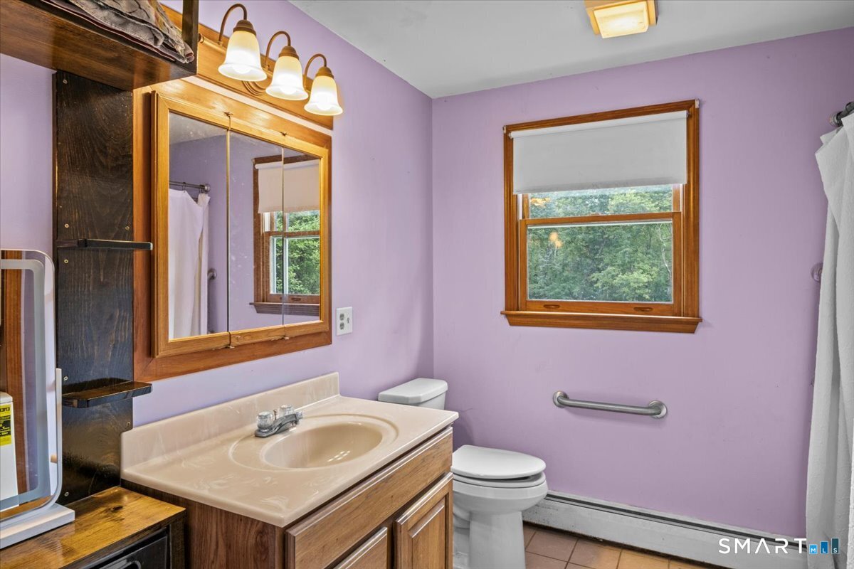88 Pompeo Road Thompson, CT 06255 - Photo 28 of 40 a bathroom with a sink and a mirror