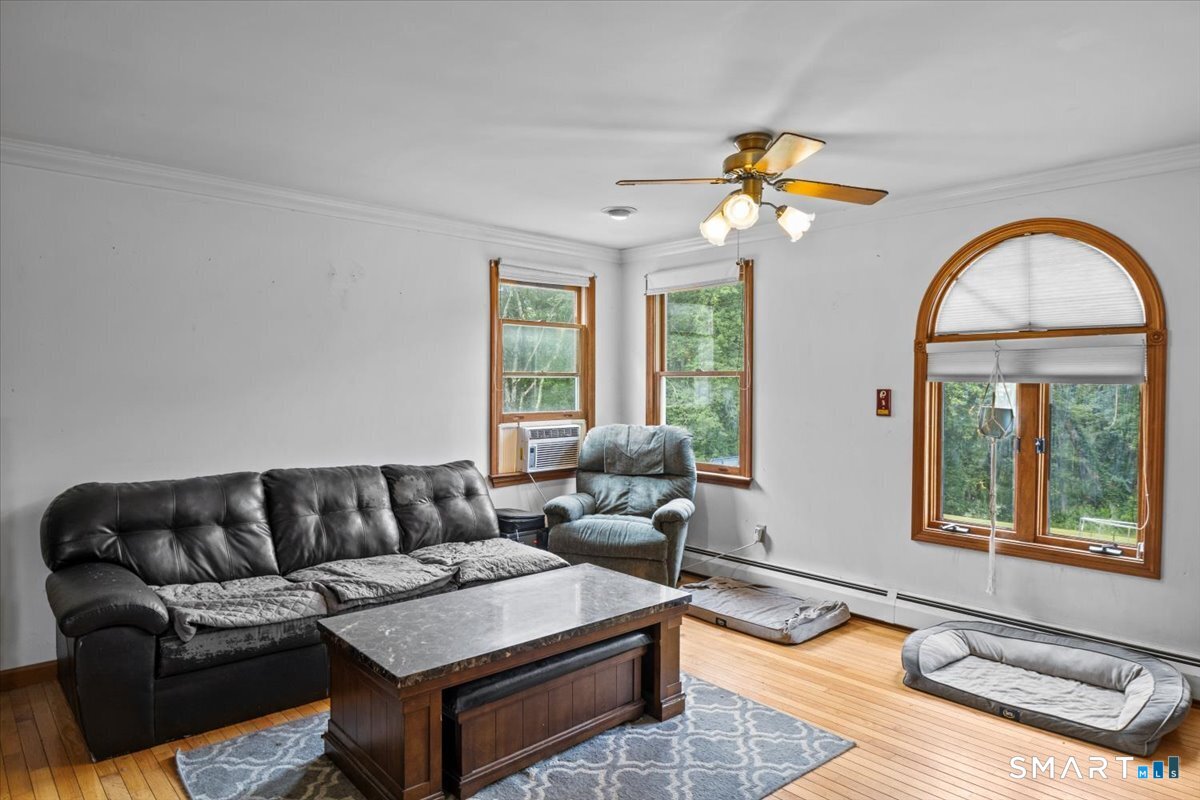 88 Pompeo Road Thompson, CT 06255 - Photo 32 of 40 a living room with furniture and a large window