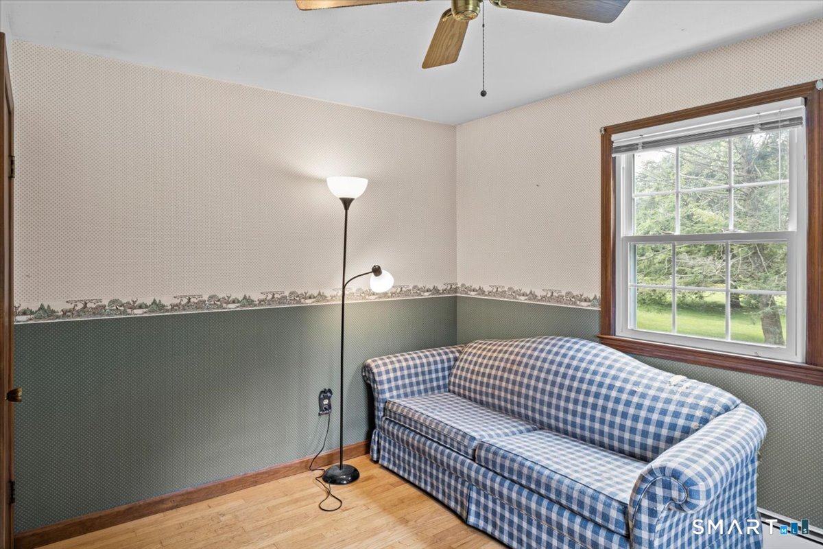 88 Pompeo Road Thompson, CT 06255 - Photo 38 of 40 a living room with a couch and chandelier