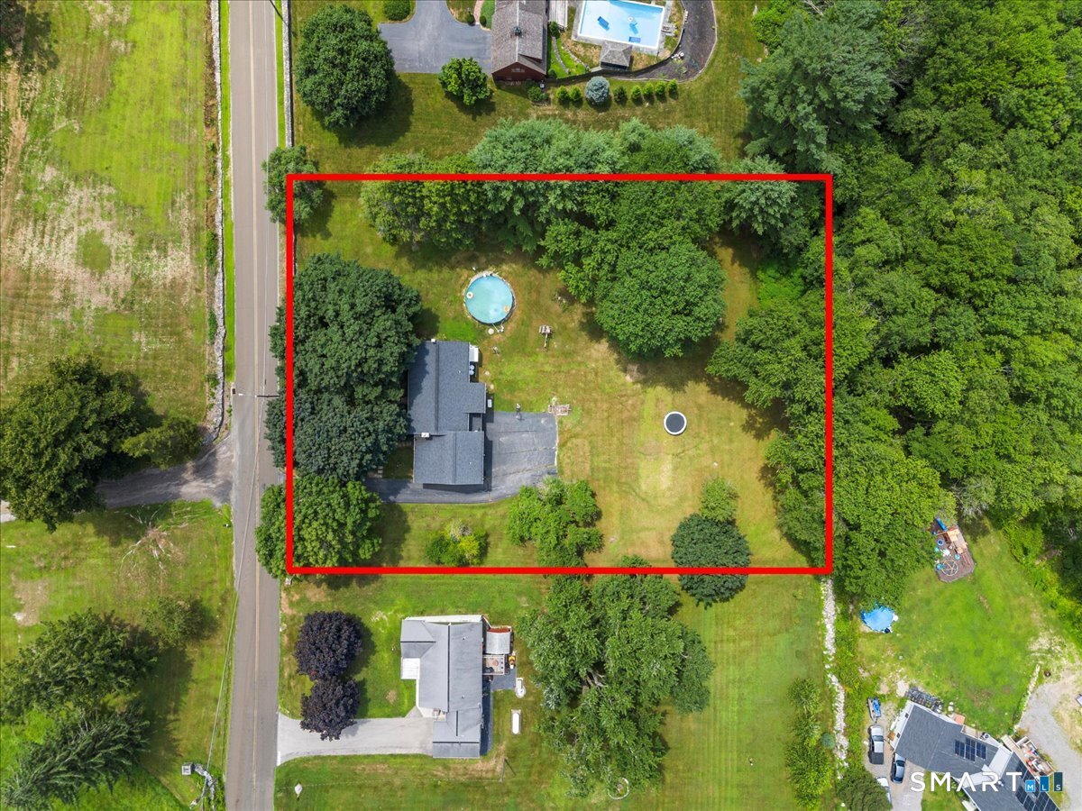 88 Pompeo Road Thompson, CT 06255 - Photo 6 of 40 an aerial view of a house with a yard and garden