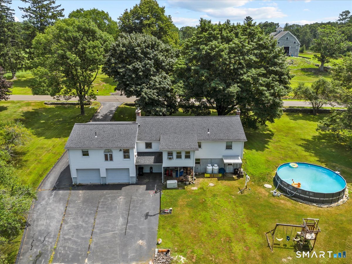 88 Pompeo Road Thompson, CT 06255 - Photo 10 of 40 a aerial view of a house with swimming pool and large trees