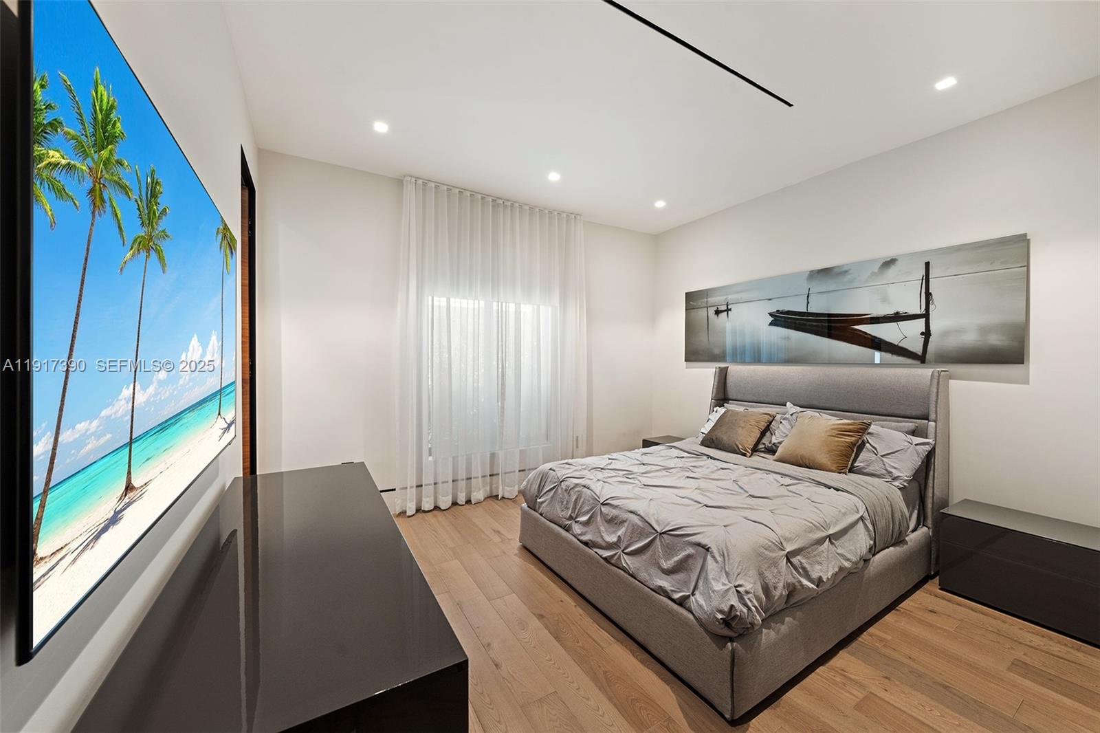 900 Washington Street Hollywood, FL 33019 - Photo 20 of 61 a bedroom with a large bed and a large window