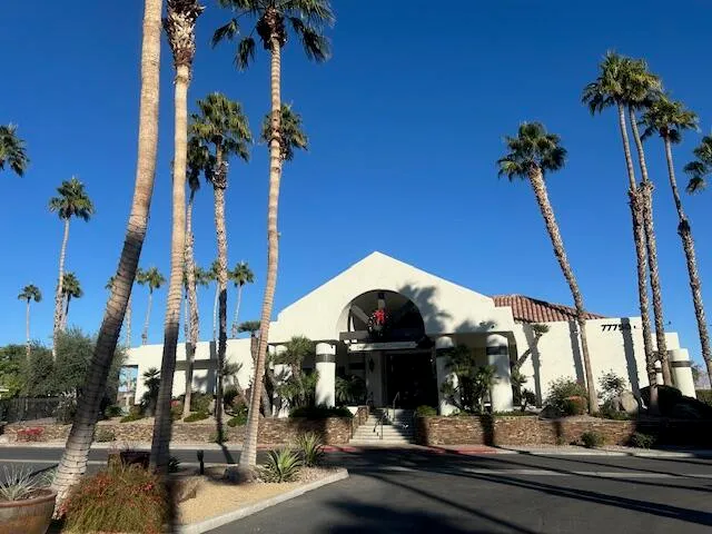 a view of a building with a tree in front of it