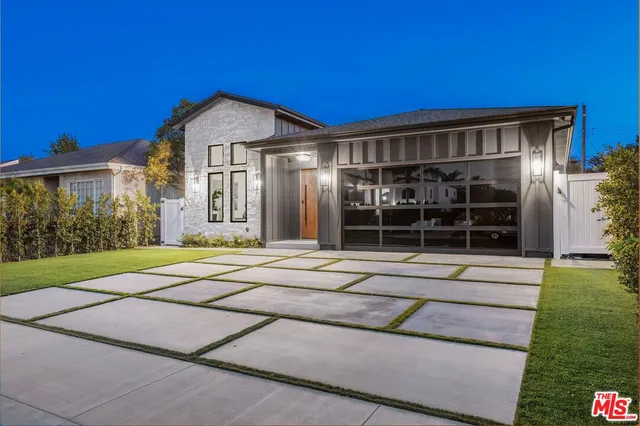 a view of a house with a yard and plants