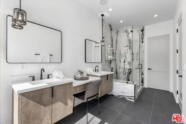 a bathroom with double sink and a mirror