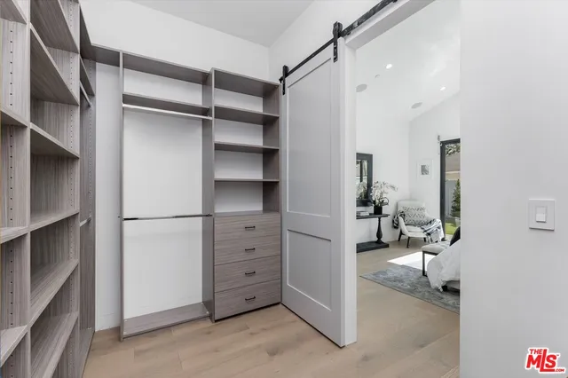 a view of walk in closet with empty racks