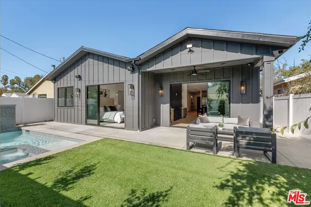 a view of a house with backyard and porch