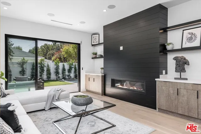 a living room with furniture and a floor to ceiling window