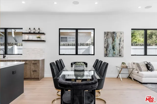 a large kitchen with a table and chairs in it