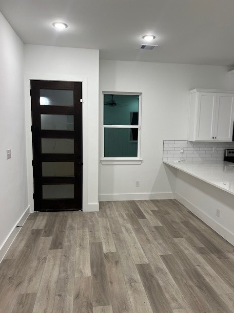 a view of an empty room with a kitchen