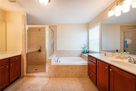 a bathroom with a tub sink shower and mirror