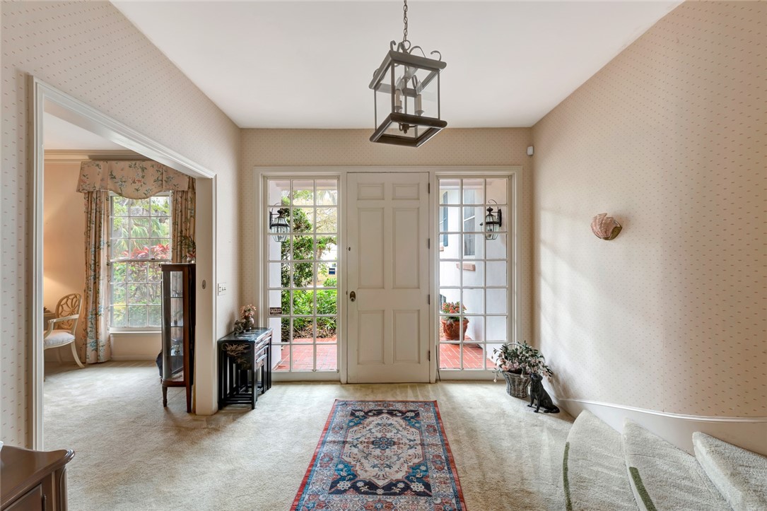 3765 Flamingo Drive Vero Beach, FL 32963 - Photo 13 of 28 a bedroom with furniture window and a chandelier