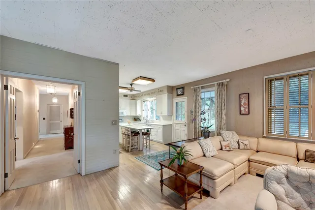 a kitchen with a stove a sink dishwasher a kitchen island with wooden cabinets and floor