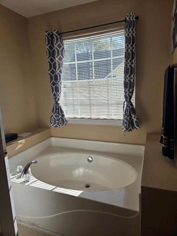 35 Pembroke Place Covington, GA 30016 - Photo 22 of 32 a bath tub sitting next to a window