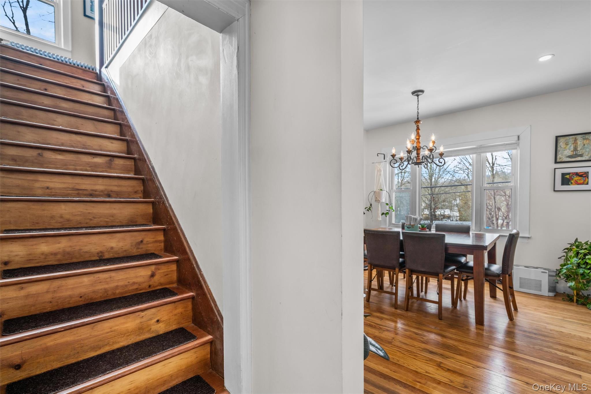 38 Post Hill Road Mountain Dale, NY 12763 - Photo 12 of 27 Staircase featuring hardwood / wood-style flooring and a notable chandelier