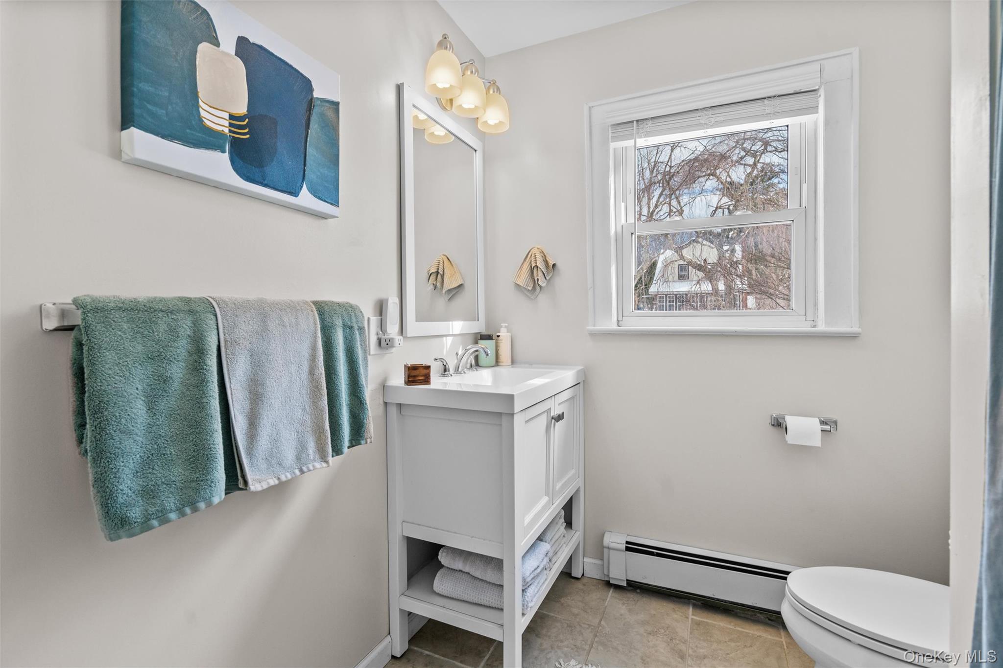 38 Post Hill Road Mountain Dale, NY 12763 - Photo 24 of 27 Bathroom with tile patterned floors, vanity, toilet, and a baseboard heating unit