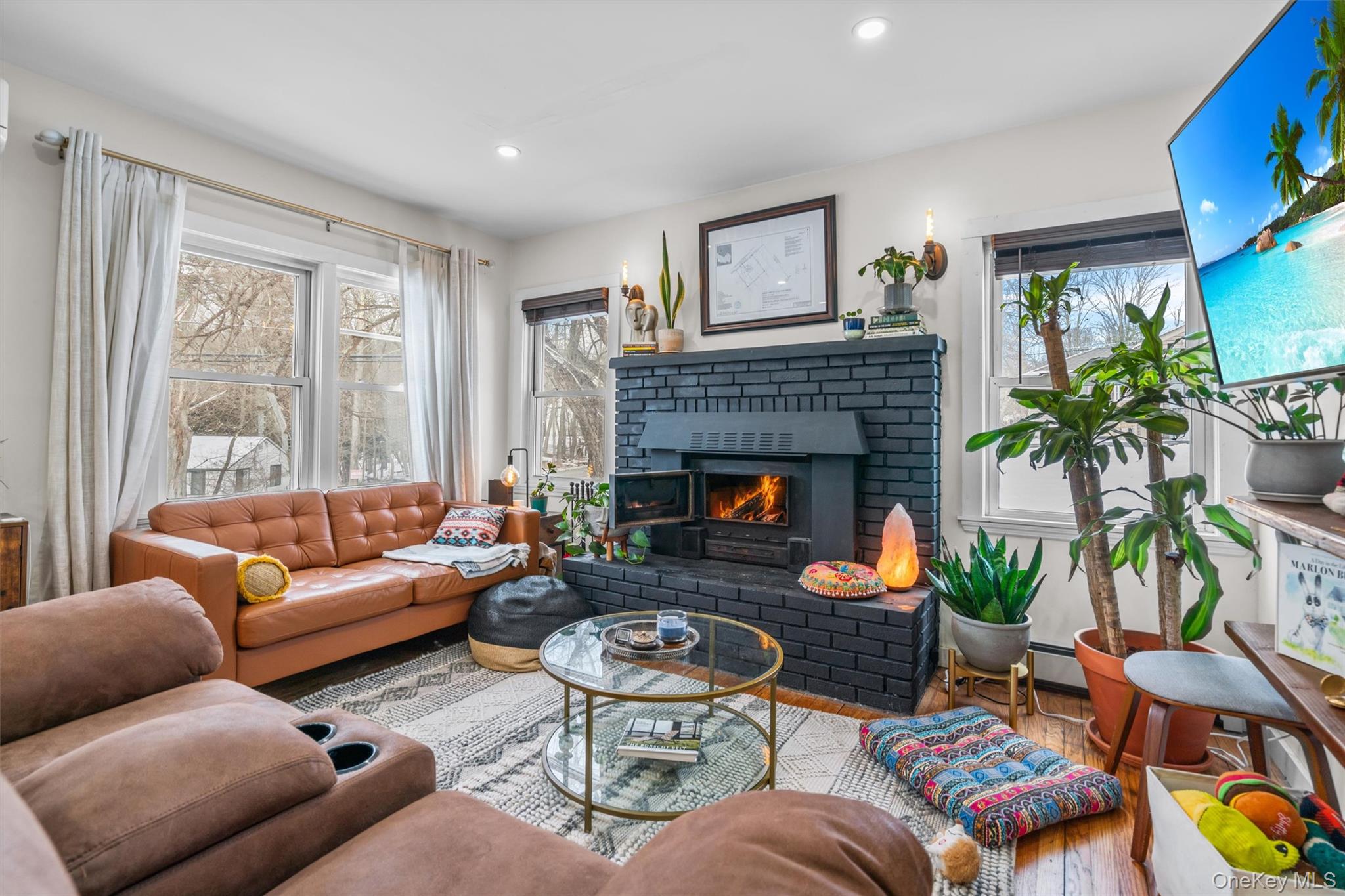 38 Post Hill Road Mountain Dale, NY 12763 - Photo 5 of 27 Living room featuring hardwood / wood-style floors, a fireplace, and a baseboard heating unit