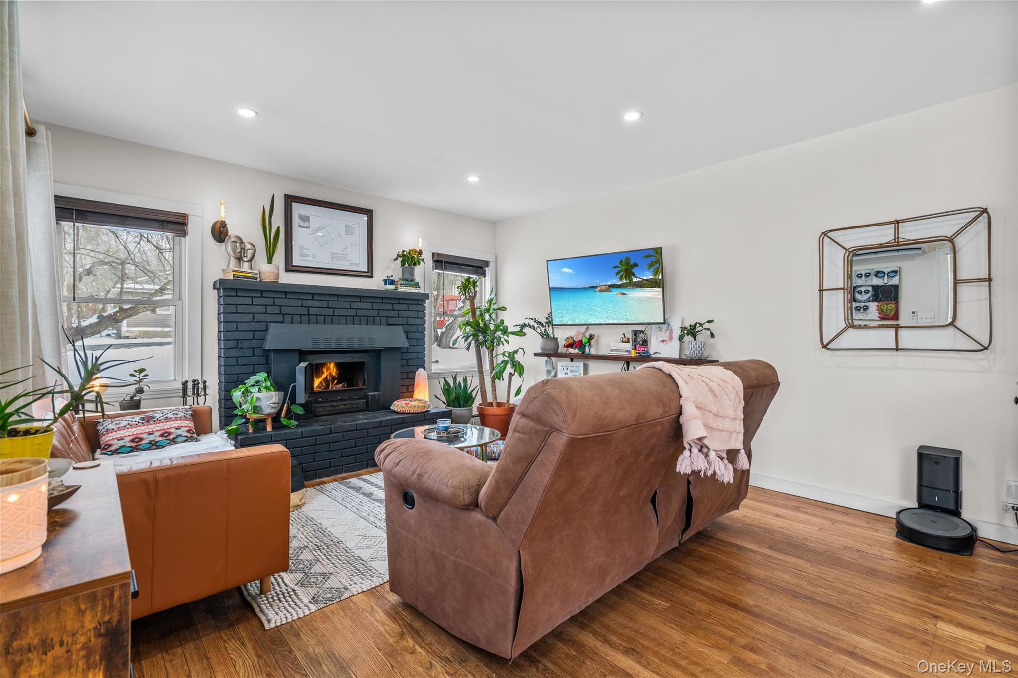 38 Post Hill Road Mountain Dale, NY 12763 - Photo 6 of 27 Living room with a brick fireplace, a wealth of natural light, and light hardwood / wood-style floors