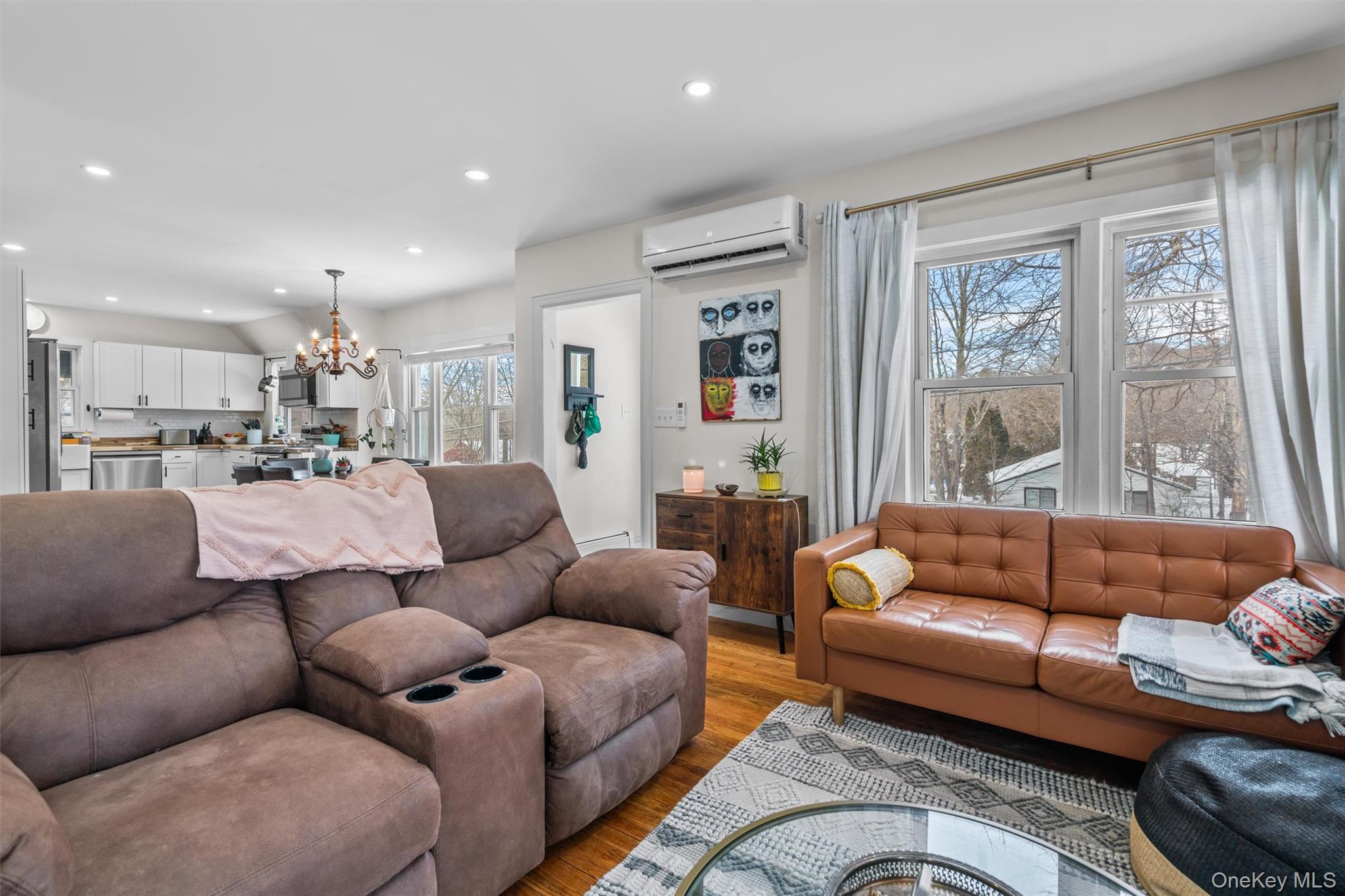 38 Post Hill Road Mountain Dale, NY 12763 - Photo 8 of 27 Living room with an inviting chandelier, plenty of natural light, light hardwood / wood-style floors, and an AC wall unit
