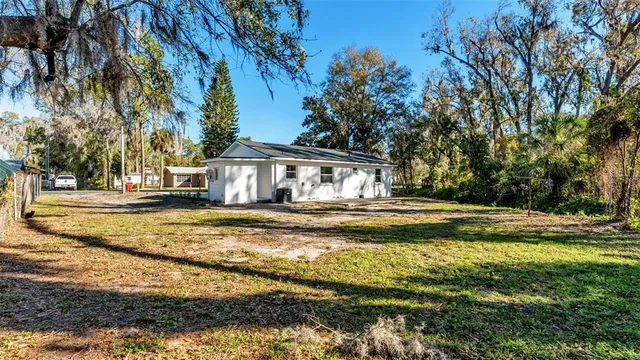 a view of a house with pool and sitting area