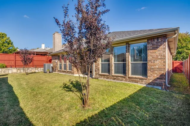a view of a house with a yard and sitting area